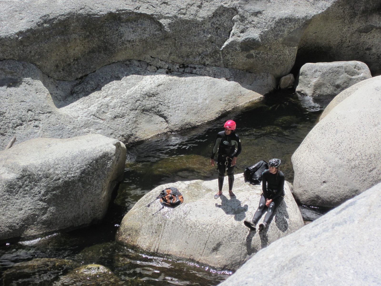 Aditi and Julia watch folks rappel down from the lunch rock.
