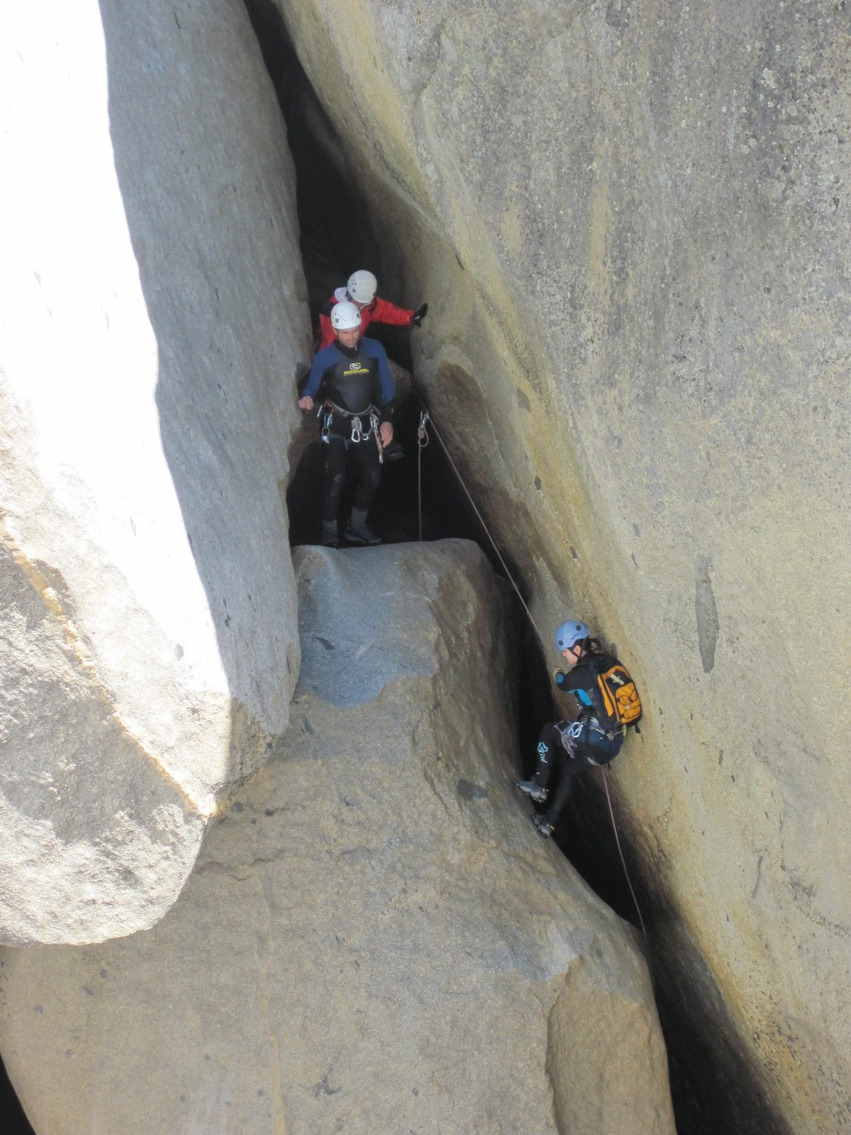 Monica on rappel while Colin and Jill look on.