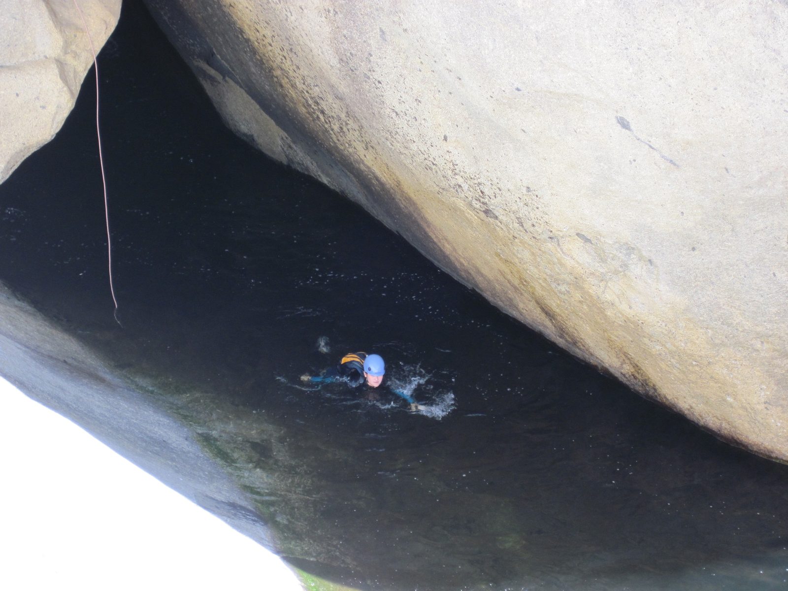Monica swimming off the end of the rappel.