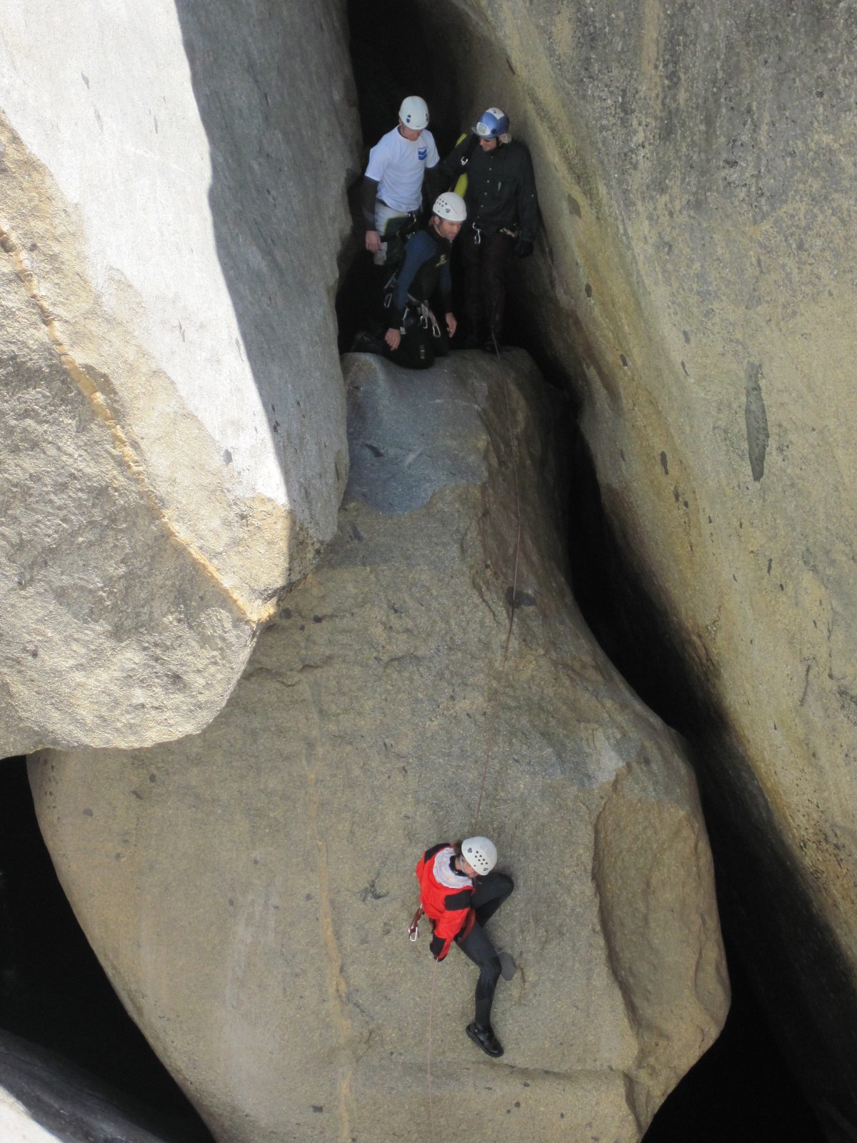 Jill on rappel. Ben, Joel and Colin watching from above.