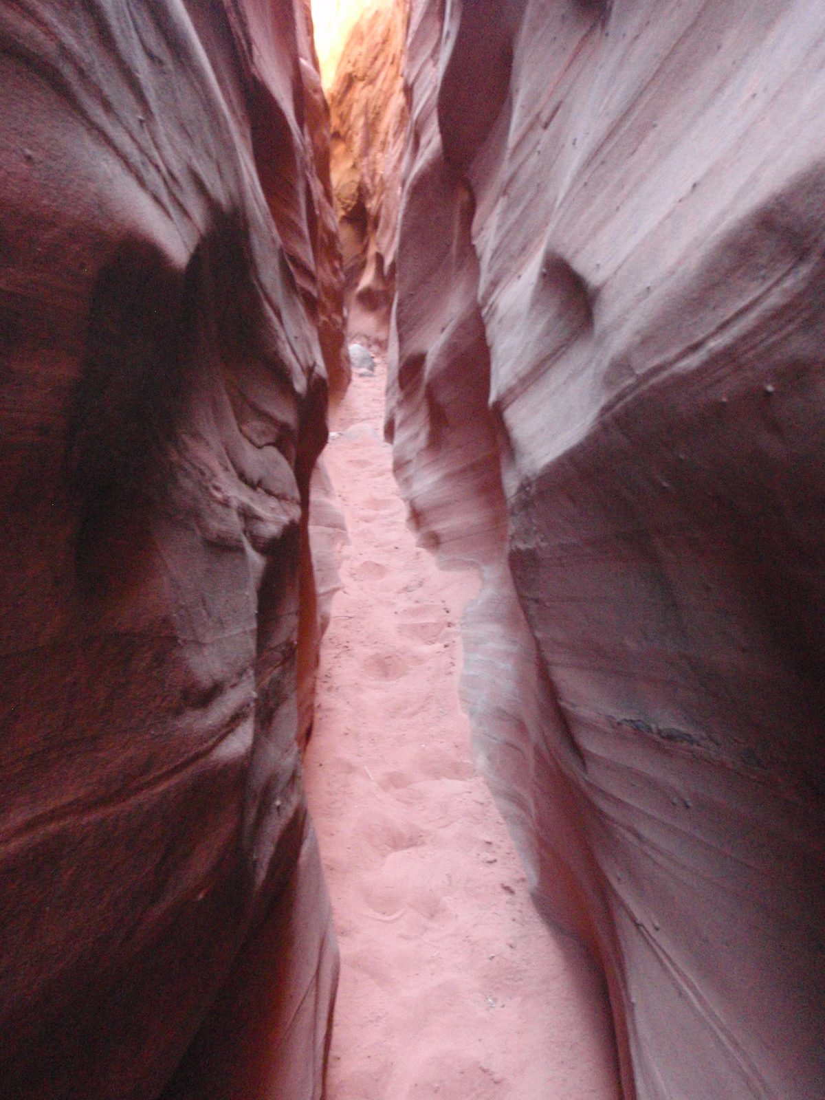 A narrow sandy slot.
