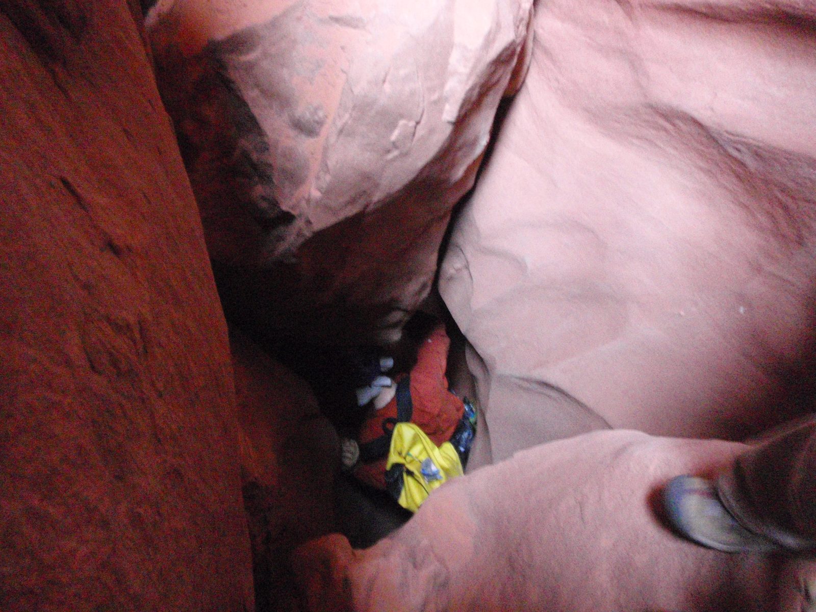 Squeezing into a particularly tight section. It didn't help that this Wile E. Coyote rock got...