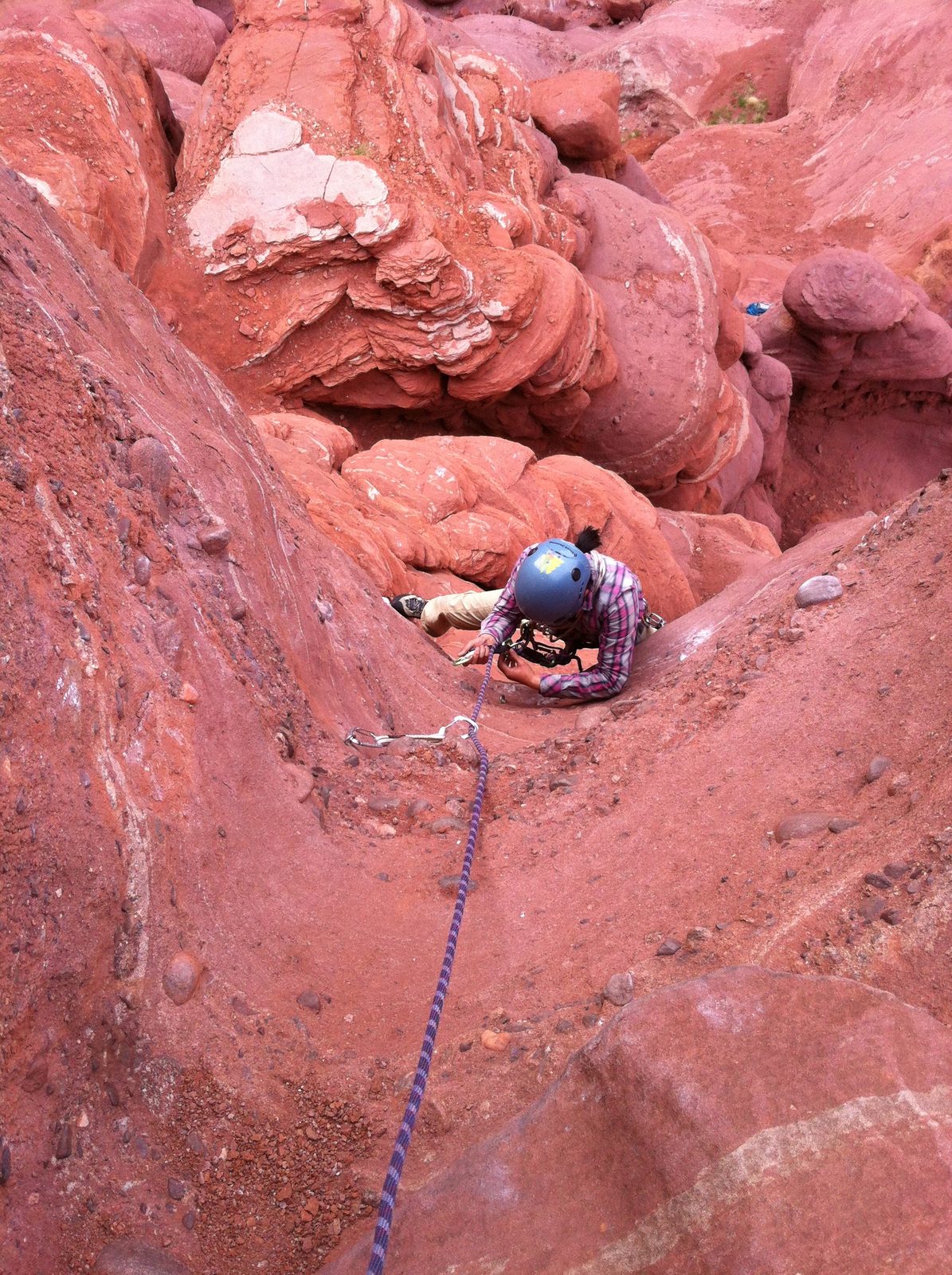 Monica working through the 5.10d crux (or 5.6 A0) on pitch 1.