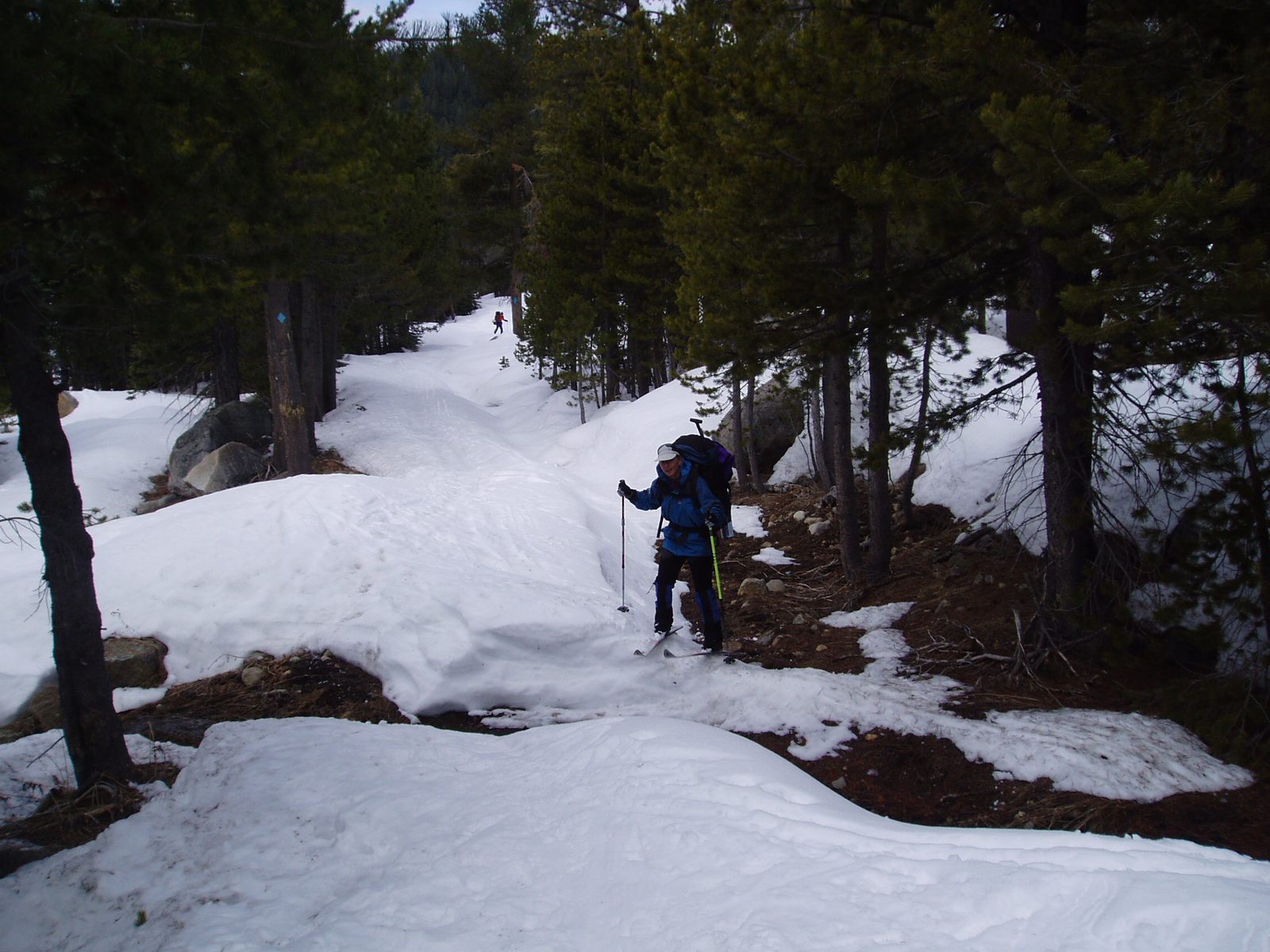 Glenda, crossing one last snow-less patch on the ski out.  (John in background.)