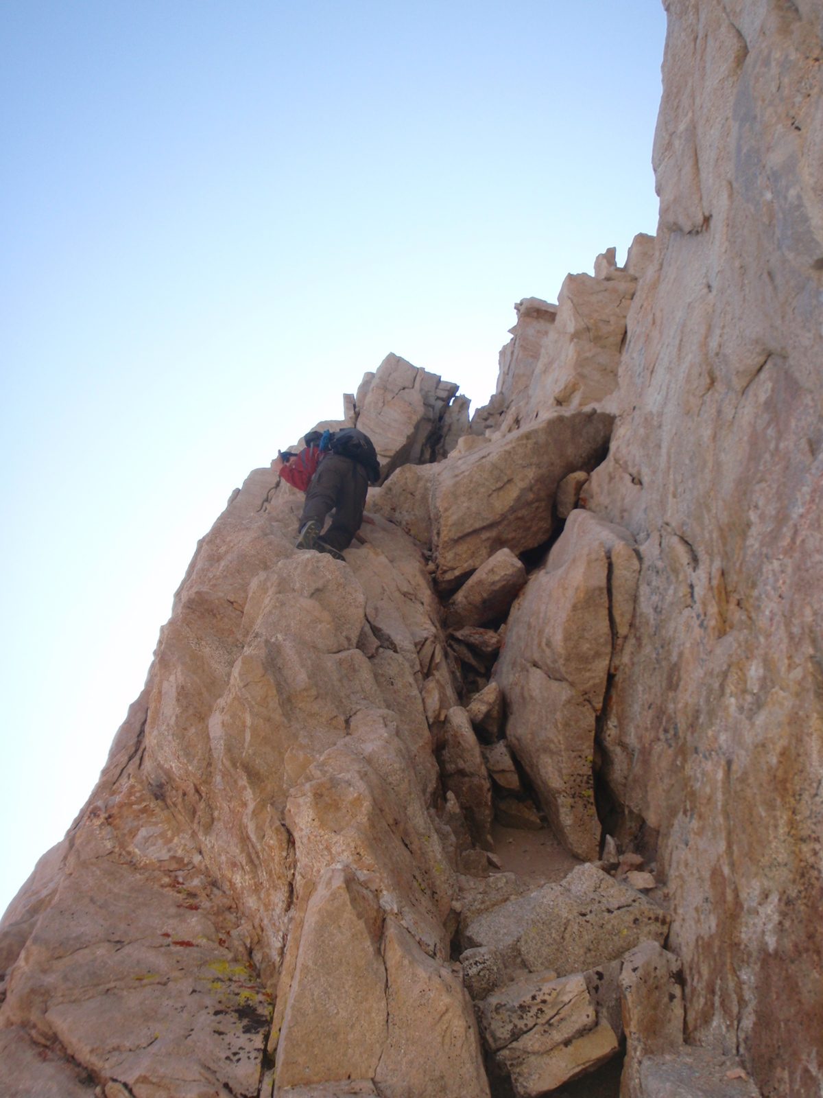 Here Joel cautiously backs down a 40 foot section of easy 5th class rock that leads to a steep...