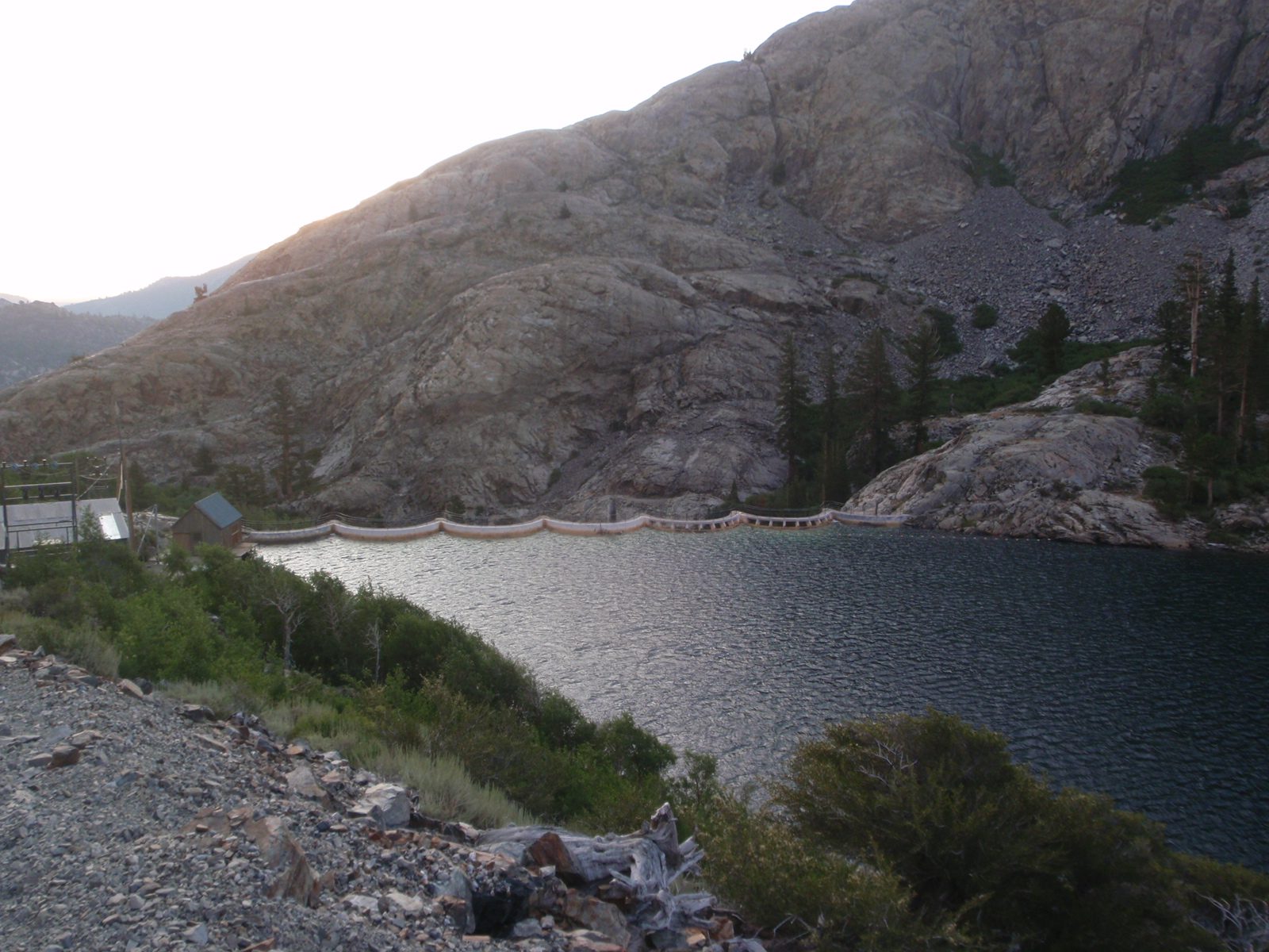 The Agnew Lake dam, complete with a control house, power boat and some railroad tracks.
