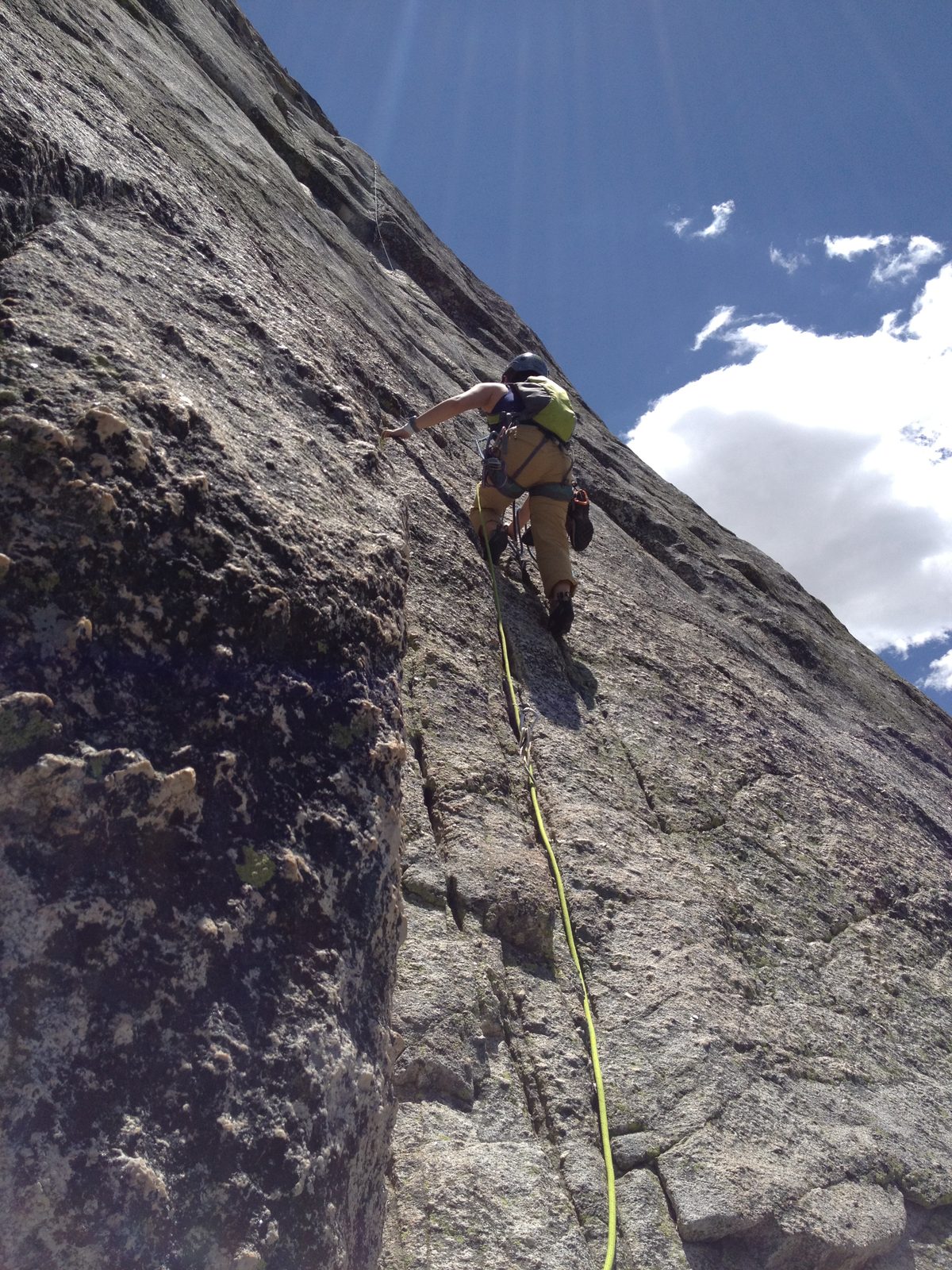 Monica climbing pitch 2 of Direct Northwest Face of Lembert Dome (5.10c)