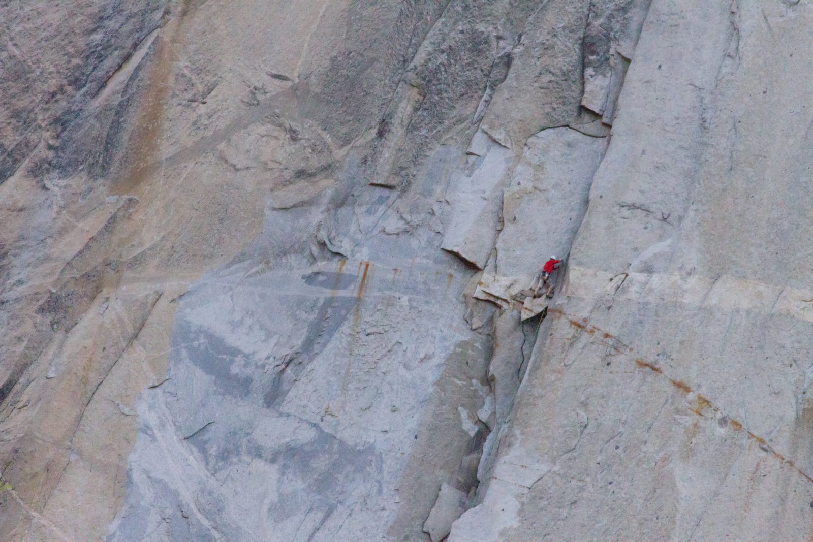 Hans leading after the pendulums, standing on a chockstone.