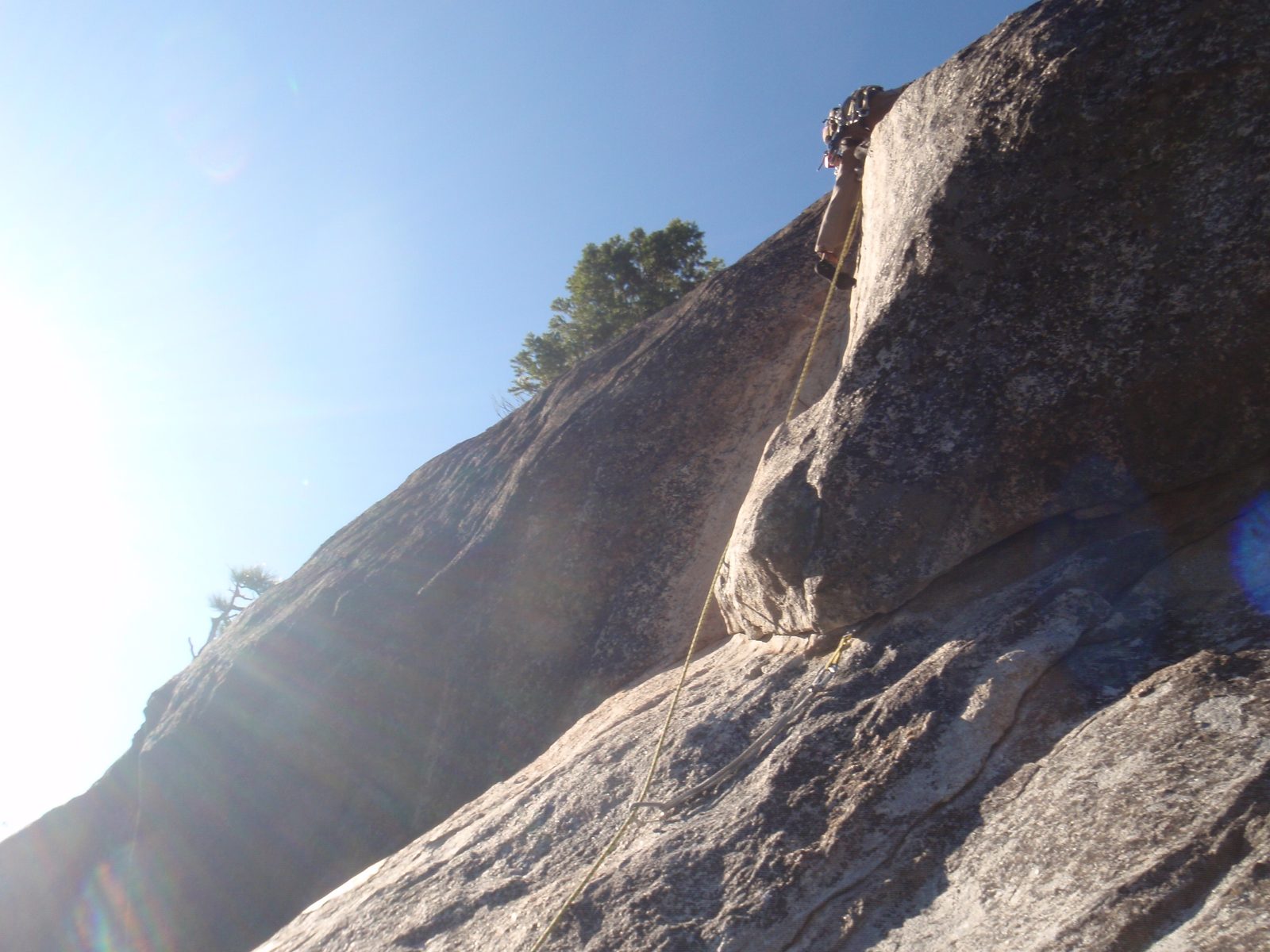 Dong, pulling the 5.8 crux of the route: a dead-vertical mantel to a ledge with another 15 feet...