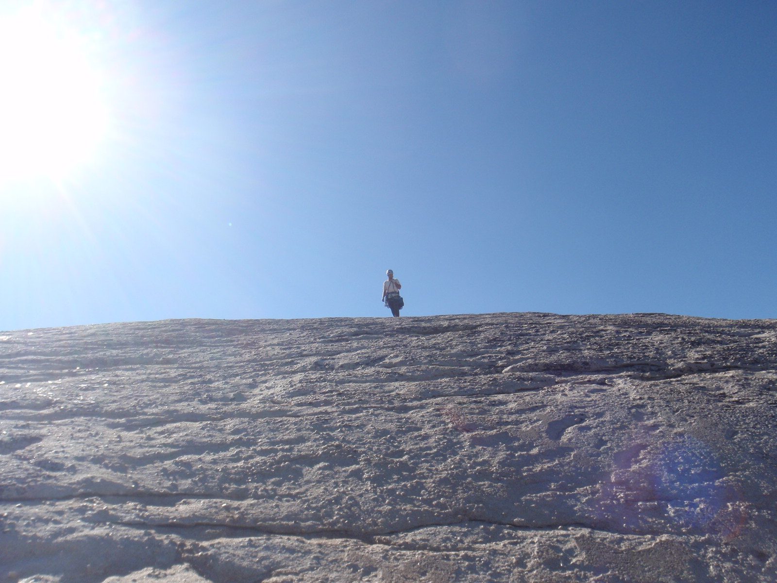Jay walking off the back side of DAFF Dome to the rappel route.