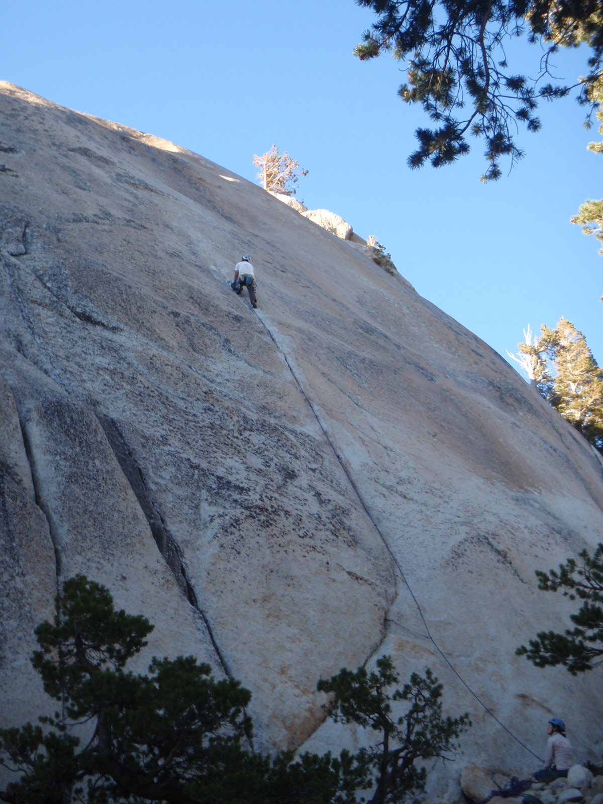 Finger crack leading to low angle, gold-colored very polished rock.