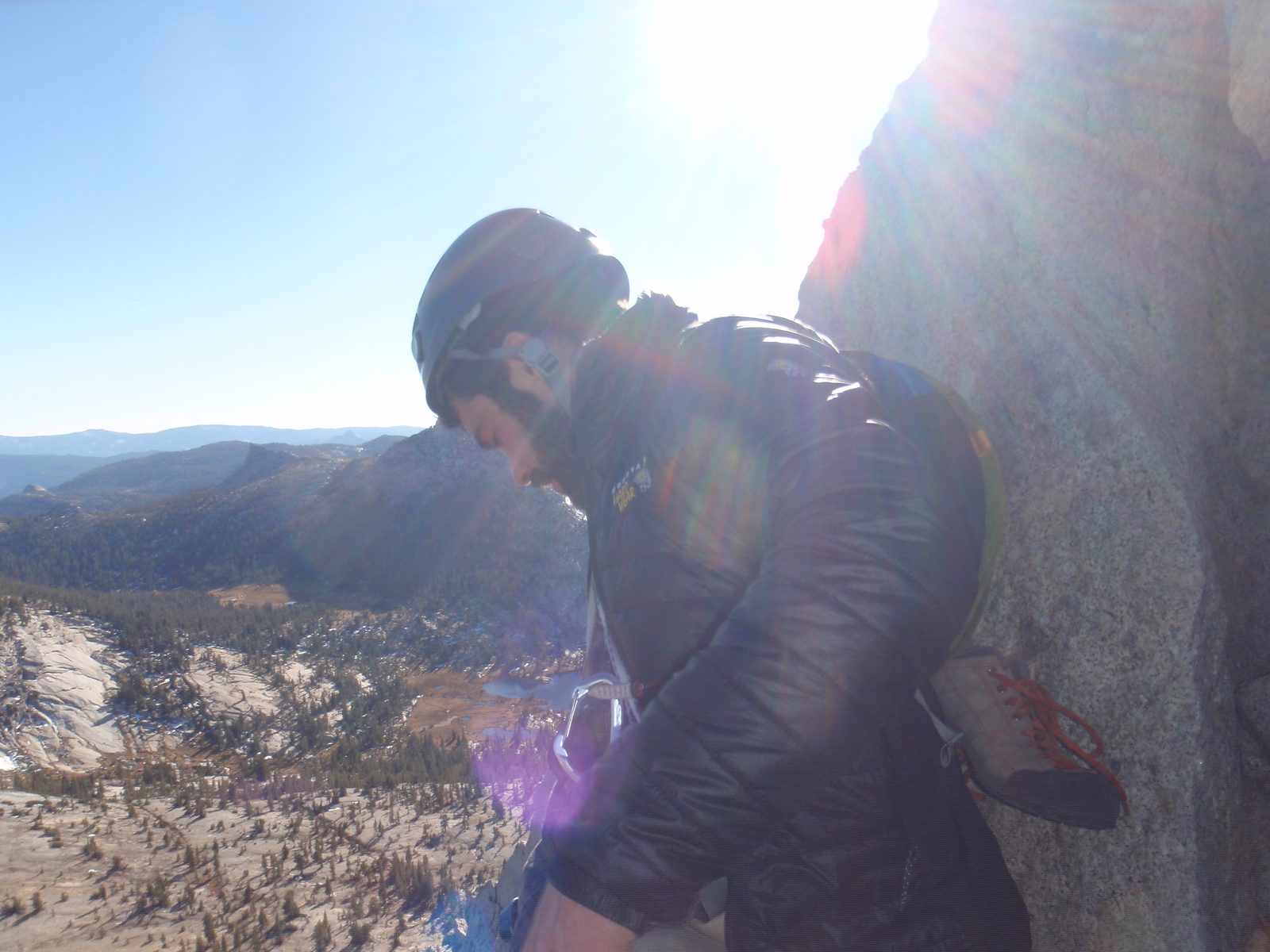 Alex looking down from the top of pitch 4. Cathedral Lakes are almost visible in the background.