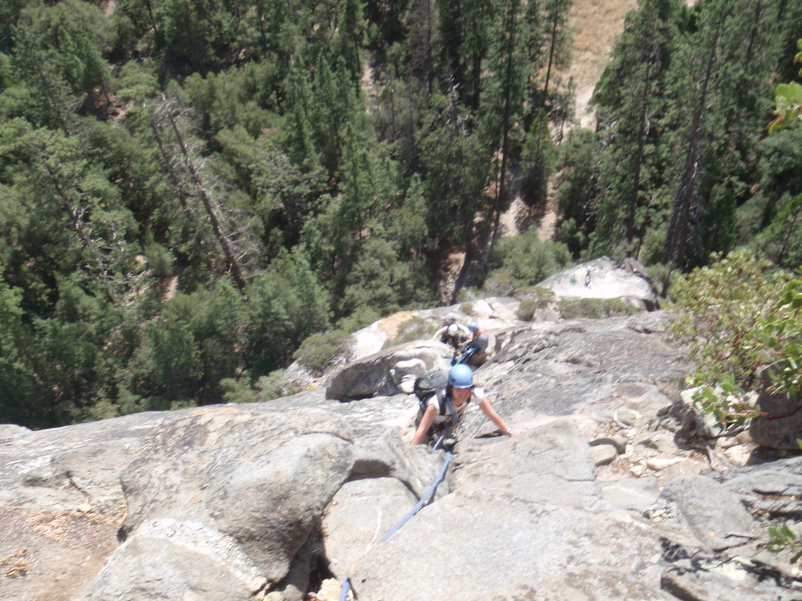 Blurry picture of Monica climbing the third pitch of After 7, with Marlin and Dong in the...