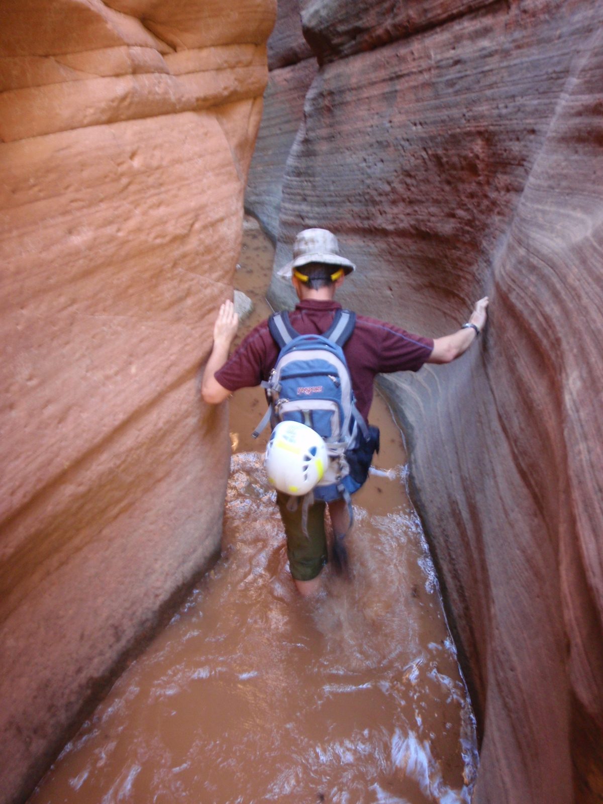 Andy wading through some Utah brown water in Keyhole Canyon.