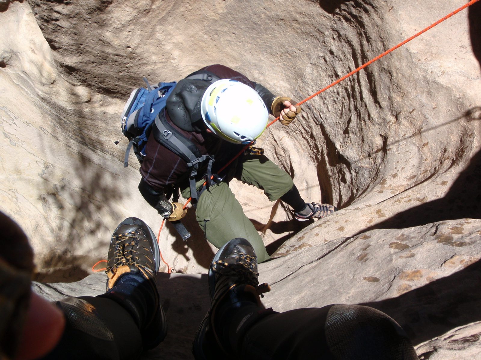 Andy on the first rappel in Pine Creek.  My feet in the foreground.