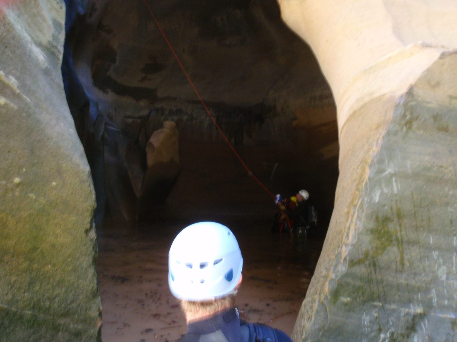 Mike looking on (from dry ground), while Andy and Joel pull the rope after a successful rappel.