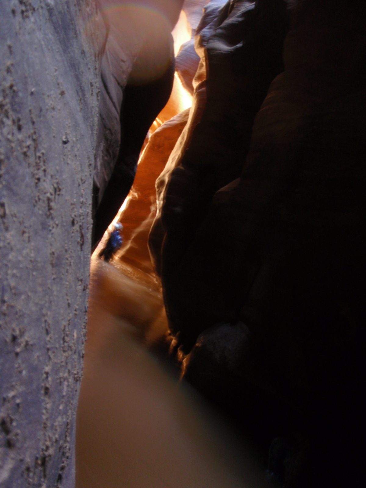 Andy reaches daylight at the end of a dark section of narrows in Pine Creek Canyon.