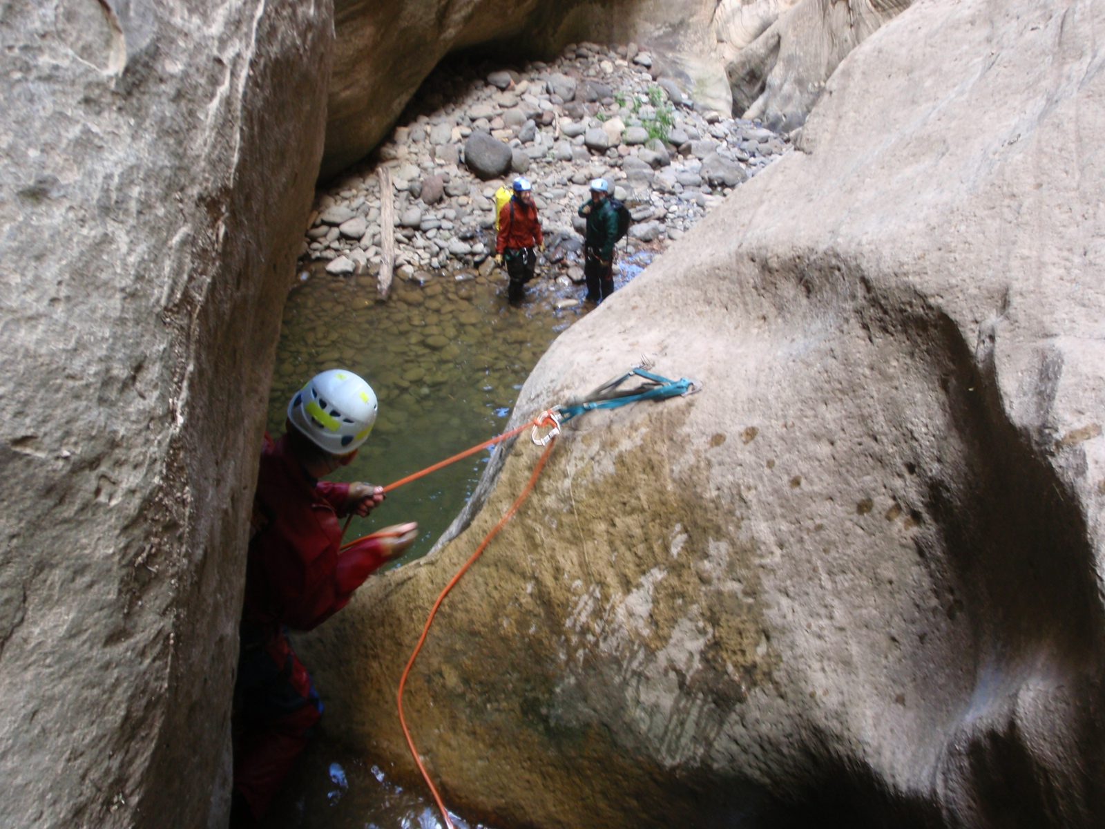 Andy starts a short rappel while Joel and Mike wait on shore.  We were sure glad to be wearing...