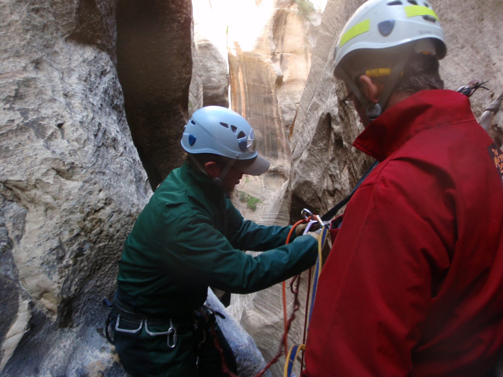 Mike rigs a locking carabiner to the anchor in a configuration known as a "biner block", which...