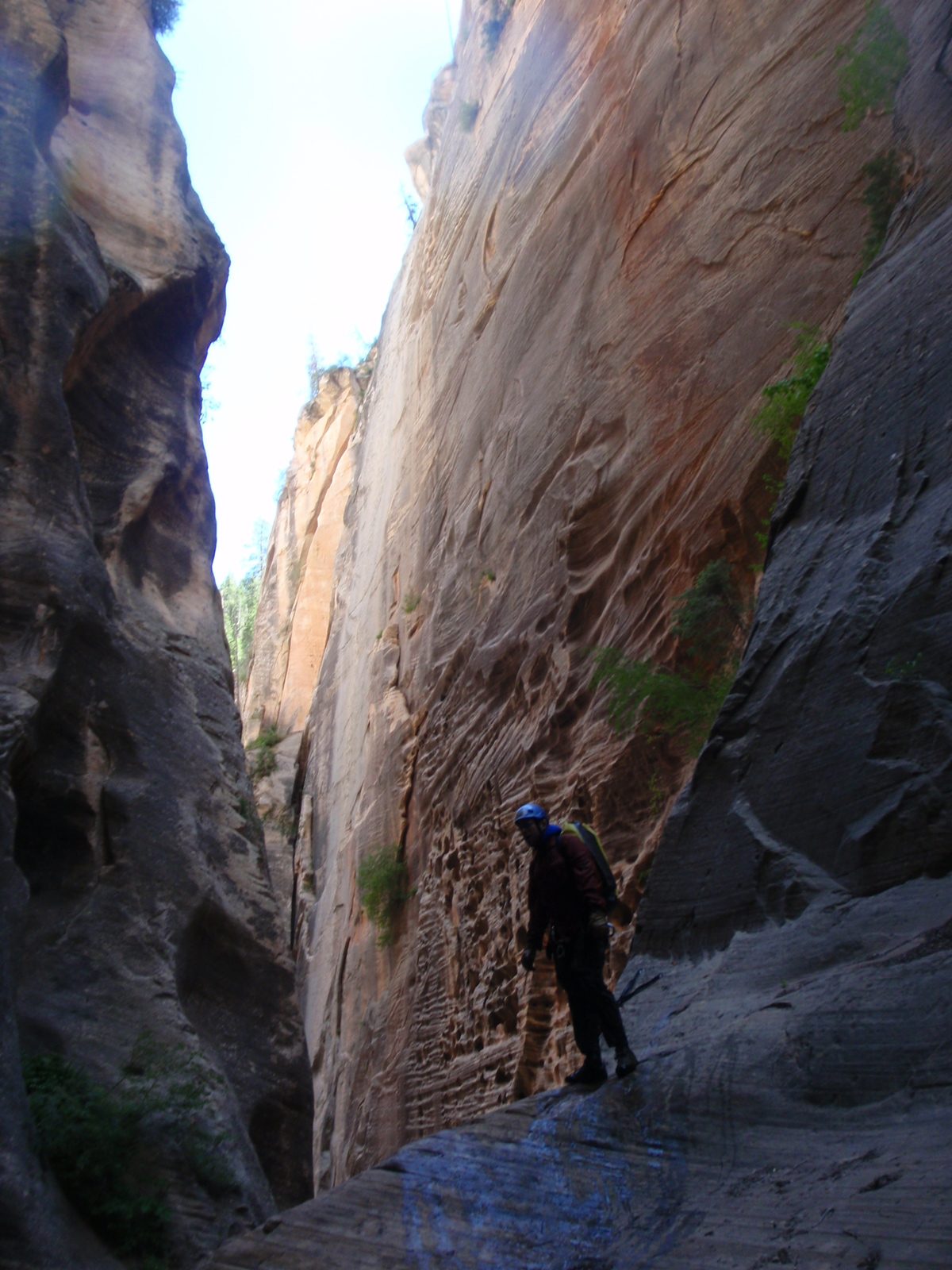 Joel, having found the anchor for the next rappel waits to get a rope that will be usable for...