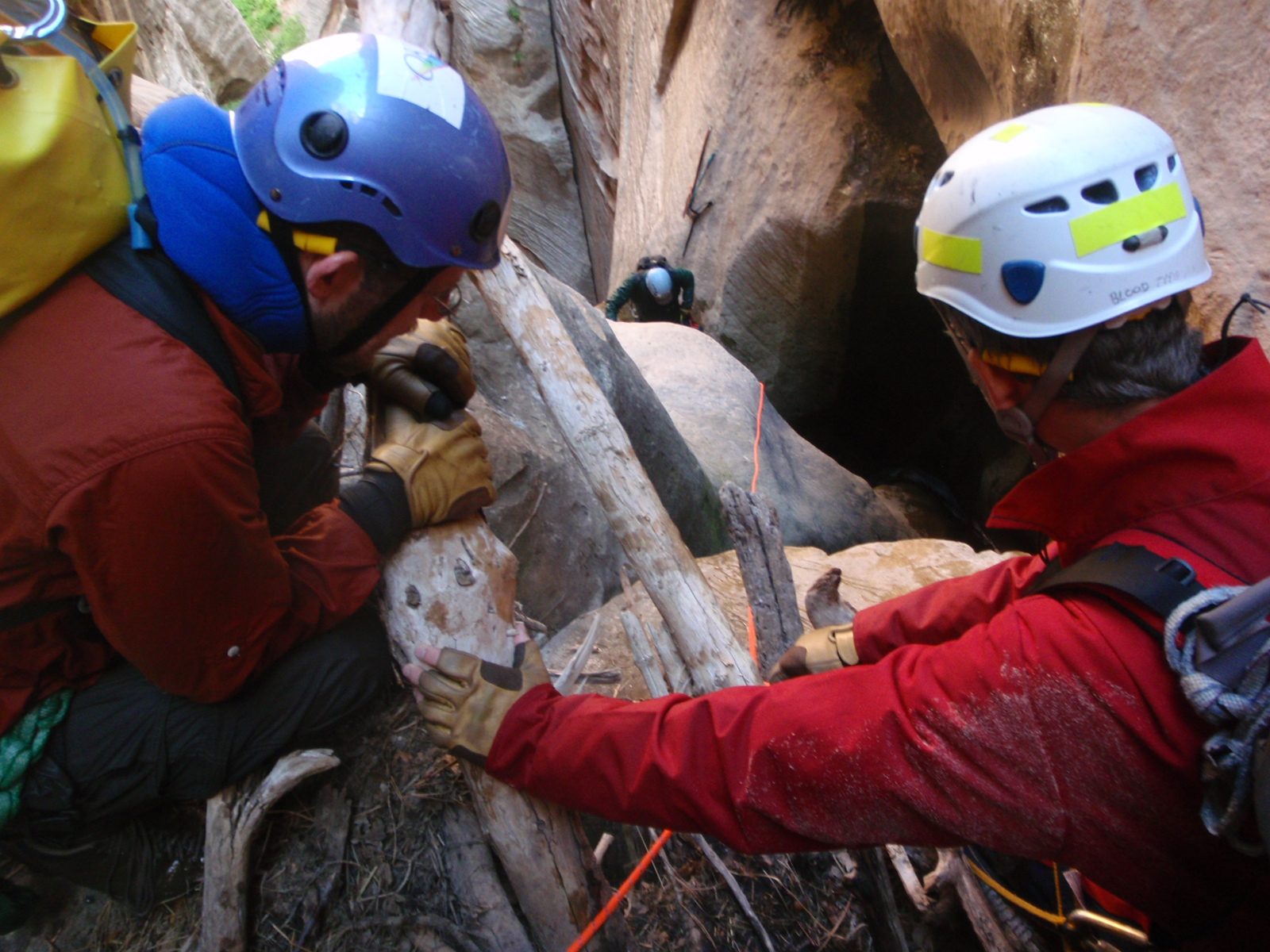 Joel and Andy crouch amid a massive log jam that served as an anchor for yet another rappel.