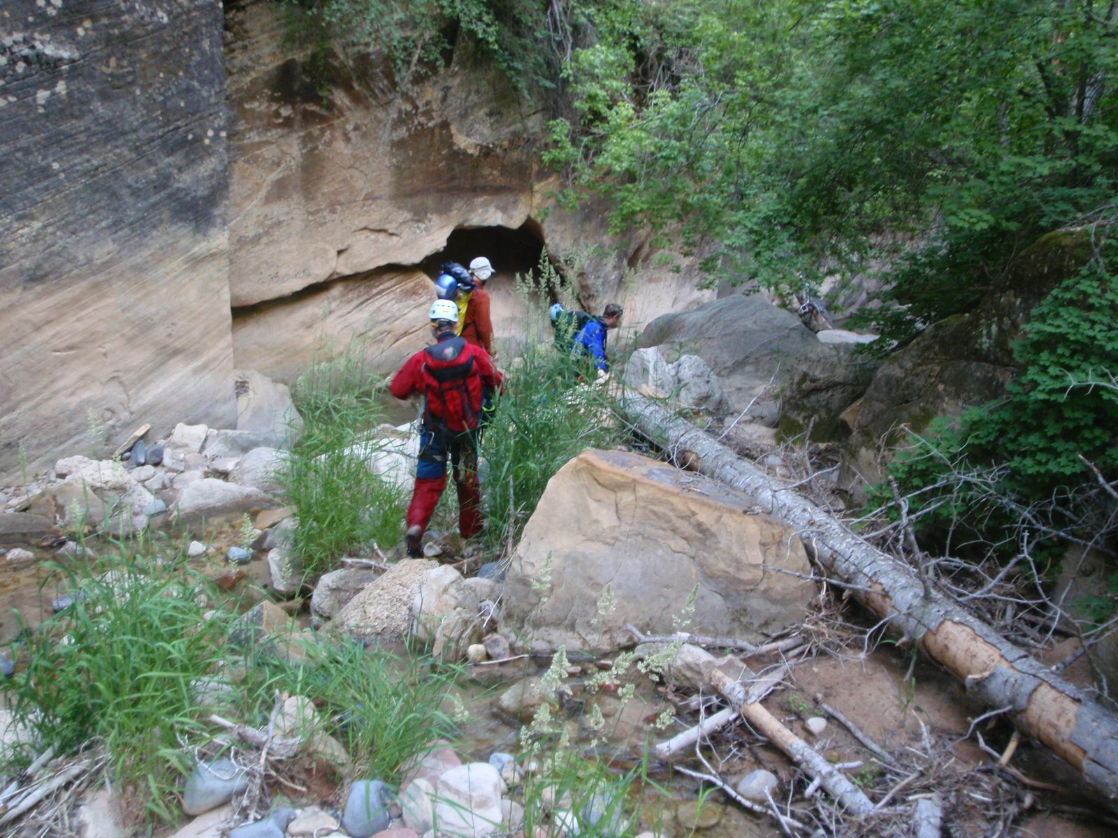 Andy Joel and Mike negotiate around some trees and logs in the stream bed, which was dry in this...