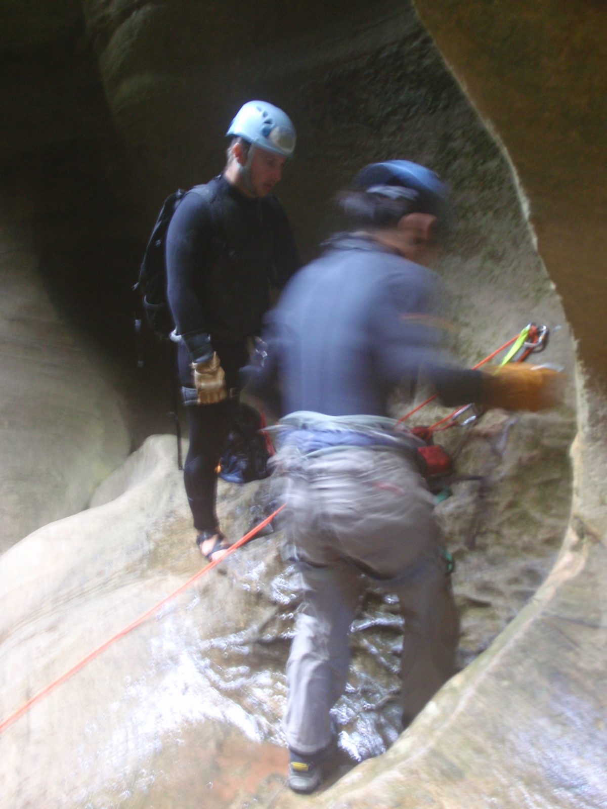 Monica rigs her rappel while Mike stands by to double-check her work.