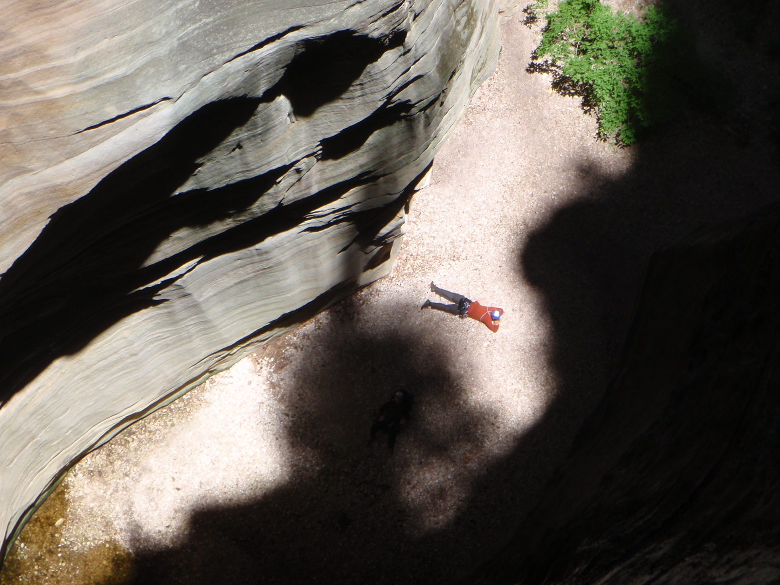 Joel lays out in the sun at the bottom of the 170 foot rappel to warm up.