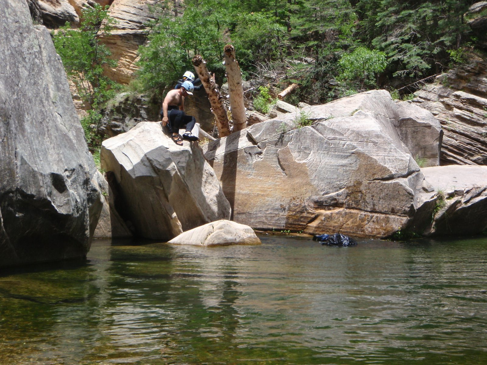 Mike (front) and Andy (rear) inspect a double-pronged diving board in West Clear Creek after...