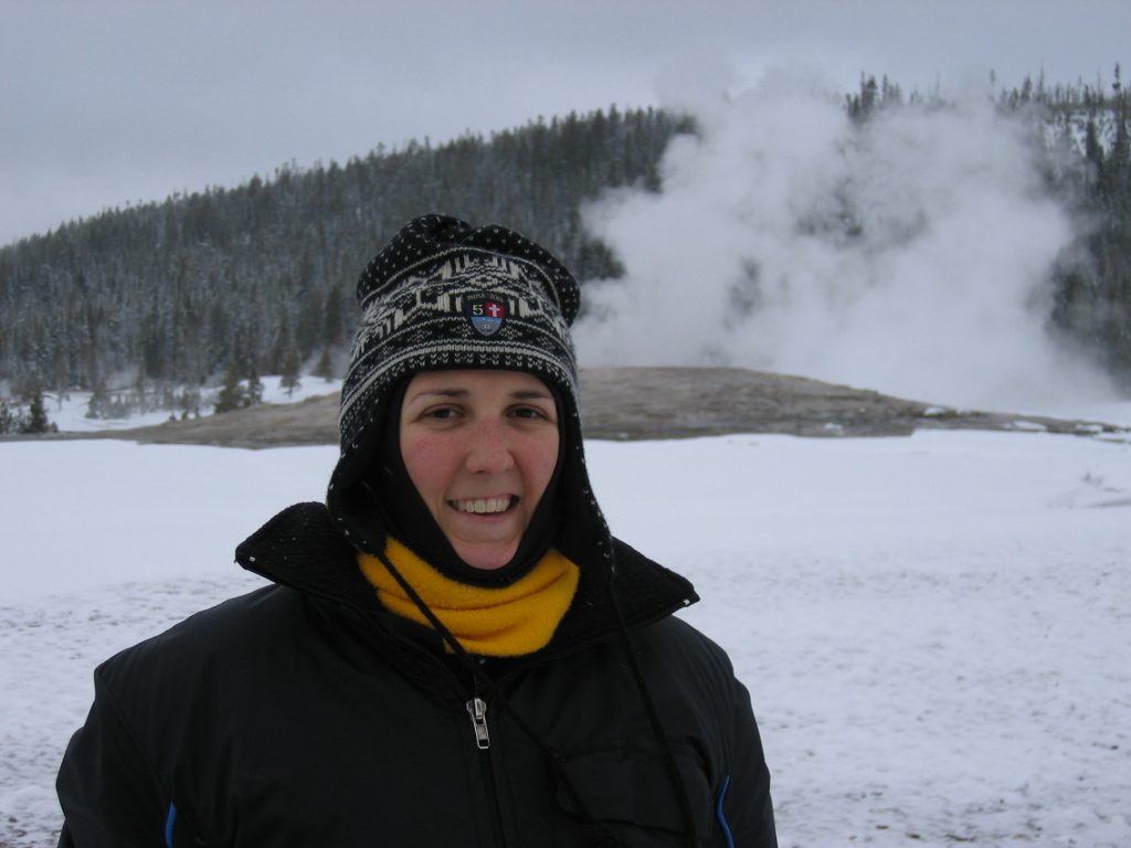 Catherine in front of Old Faithful.  For one her ear flaps are actually not sticking out.