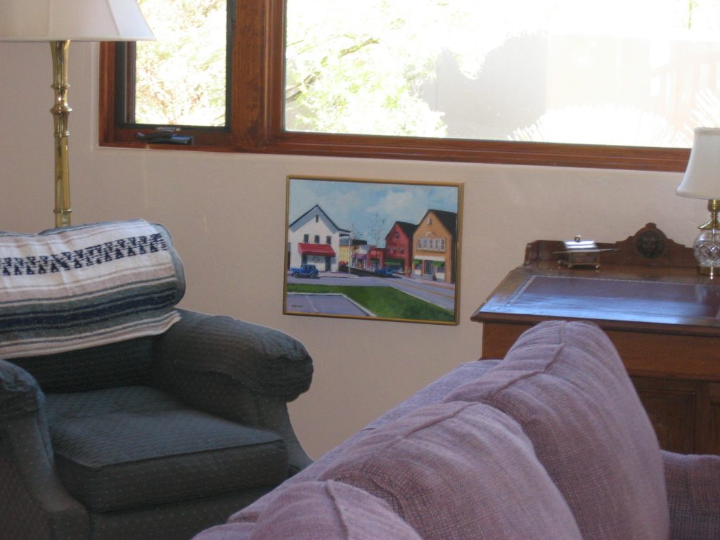 NW corner of Living Room with Nancy Gramps oil of early downtown Darien.  The artist would be in...
