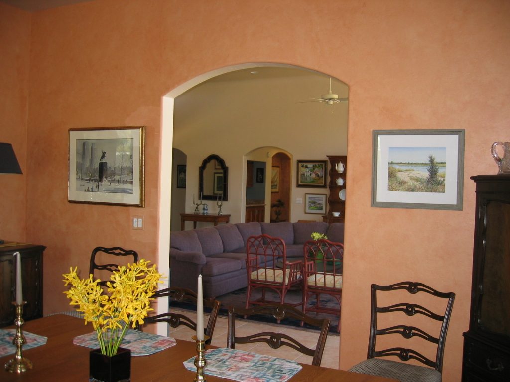 From the dining room through to the SW corner of living room.  Hall alcove with sculpture and...