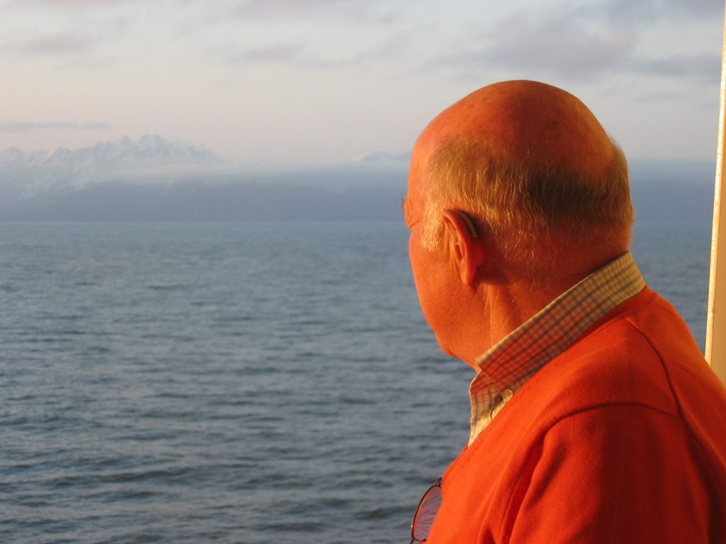 Looking back at the mainland as the Ryndam puts out to sea.  Peter on the verandah of our stateroom