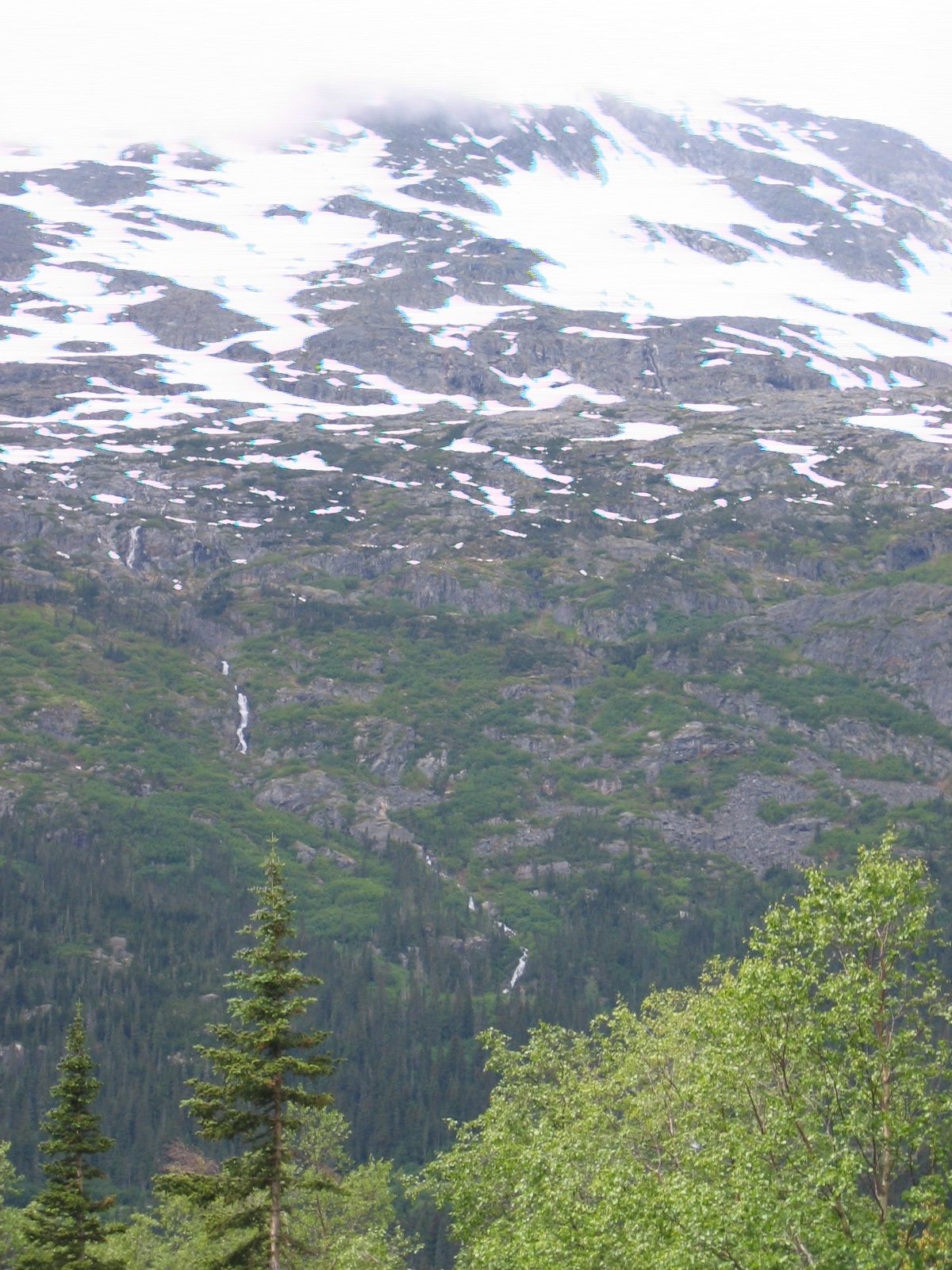 A waterfall coursing down a mountain across from where we are climbing.