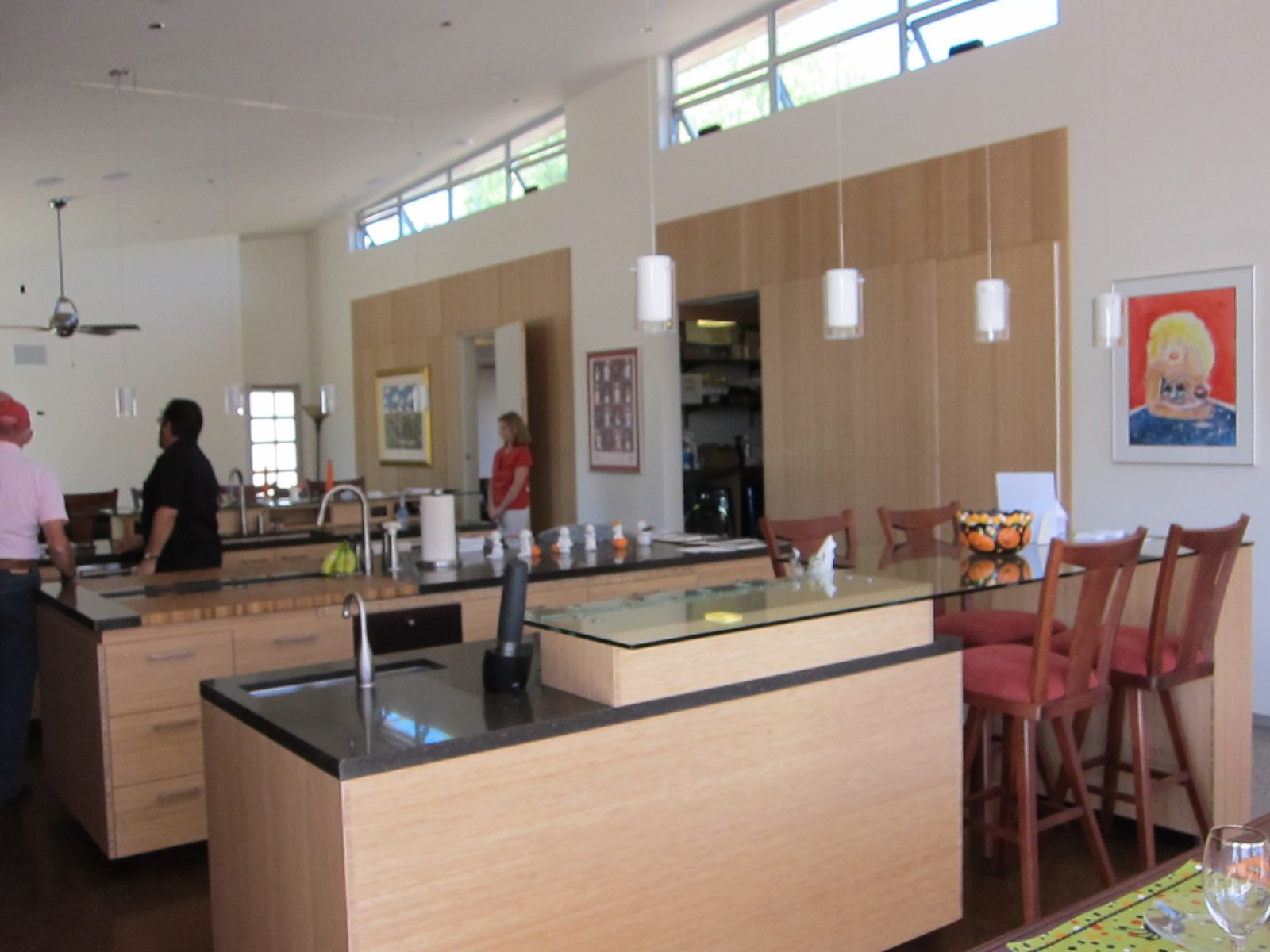 Kitchen of the LIH.  Three kitchen islands.  Closest (with large sink) is for clean up, has...