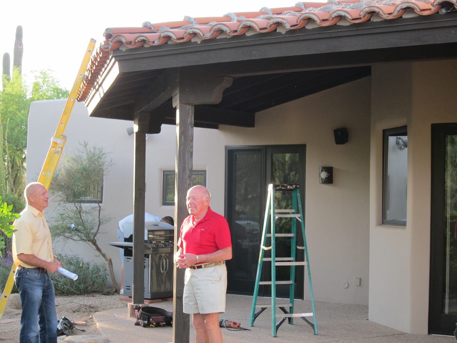 First day.  Anxious-looking homeowner consulting with Robin Hartman, our contractor.