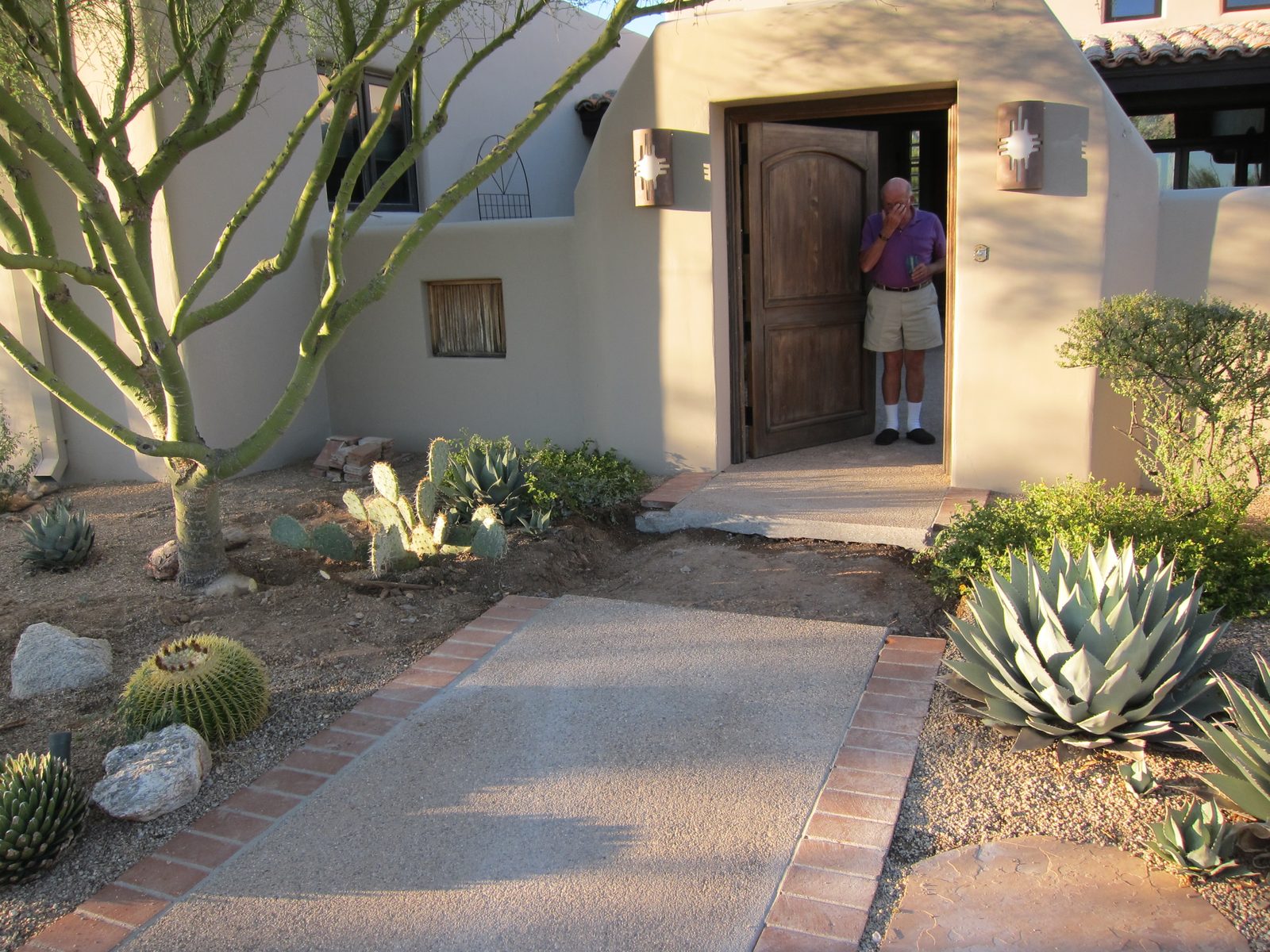 Home owner not really as distraught as he would appear.  I think he's adjusting his glasses.