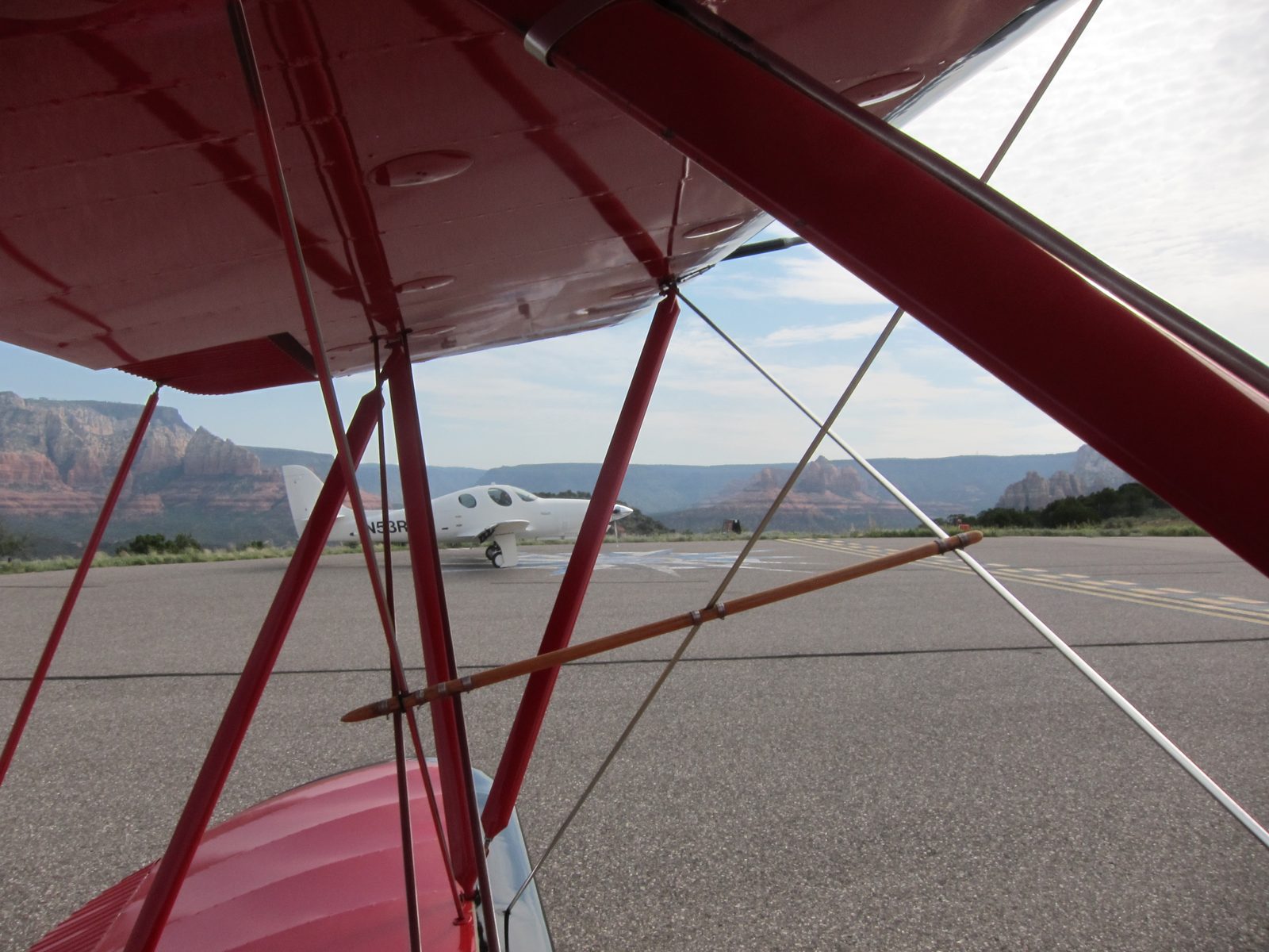 View through the various struts to an unusual plane on the tarmac.  The Sedona airport is on a...