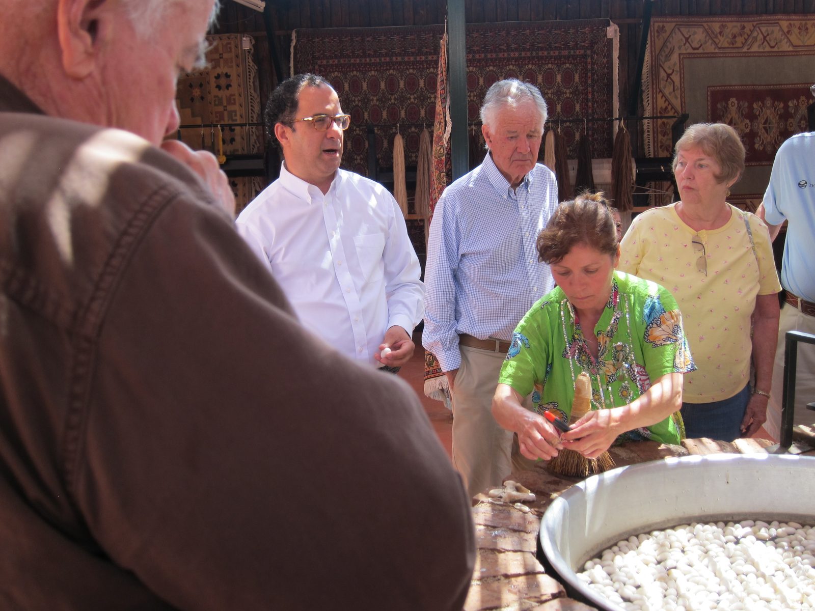 Man in the white shirt is the rug merchant who gave us a tour of his whole process starting with...