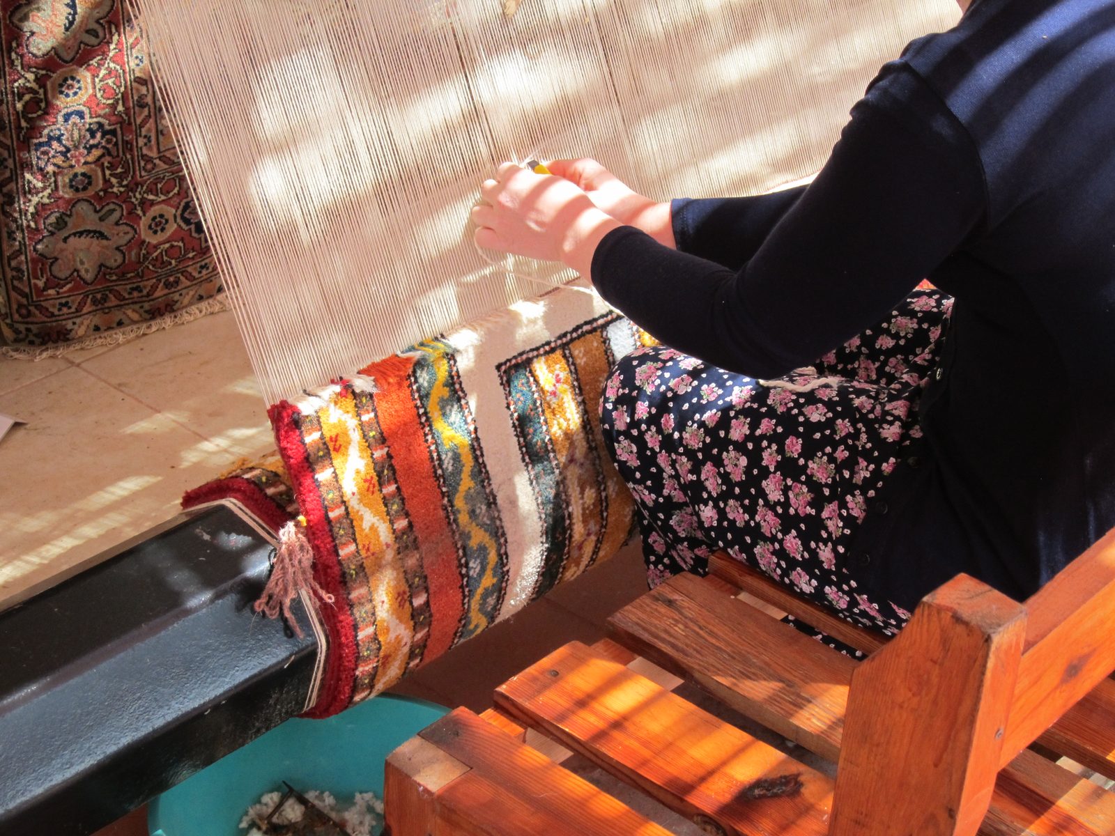 Somehow I dropped the picture of the dying vats.  But eventually it gets to the hand knotting...