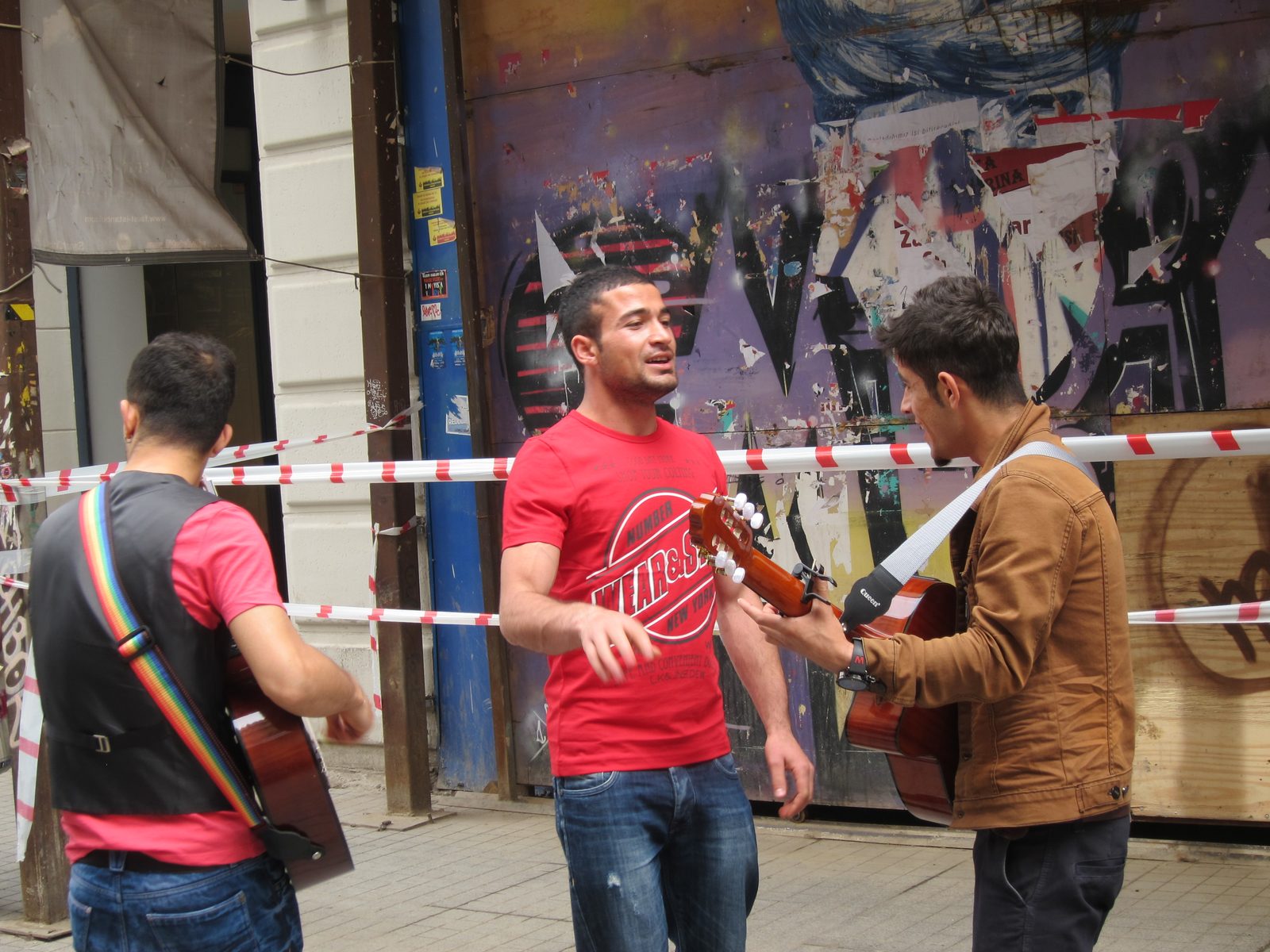 Three musicians contributing to the street scene.  Very typical Turkish men.  Dark hair, dark...