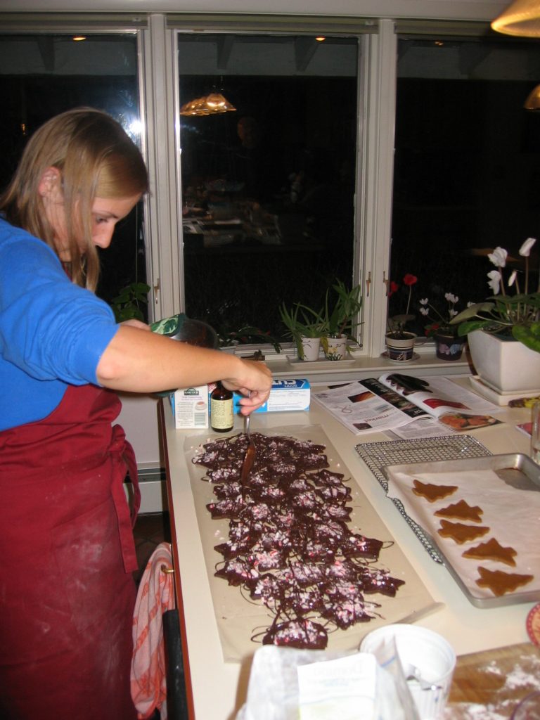 Catherine making chocolate peppermint Christmas cookies.  Gingerbread trees at far right.