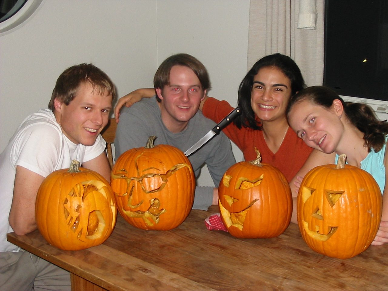 John, Jack, Anamaria, and Rachel with their respective carved pumpkins.
