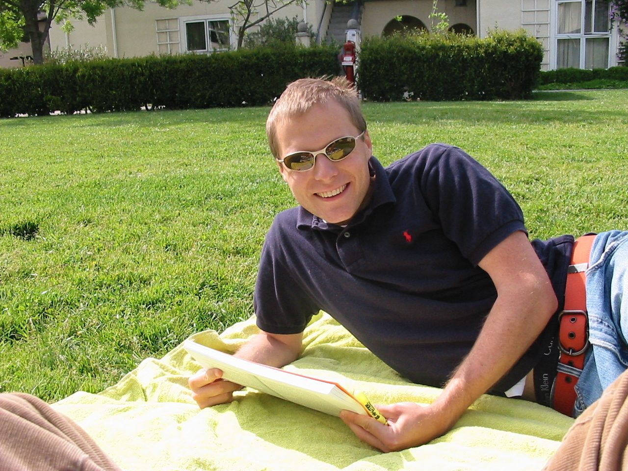 John doing some school reading in the sun outside Building 6 in Rains.