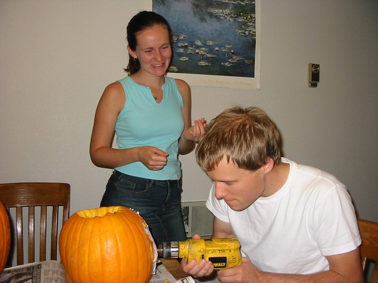 The only way to carve a pumpkin.  John at work while Rachel looks on.  I think I was making the...