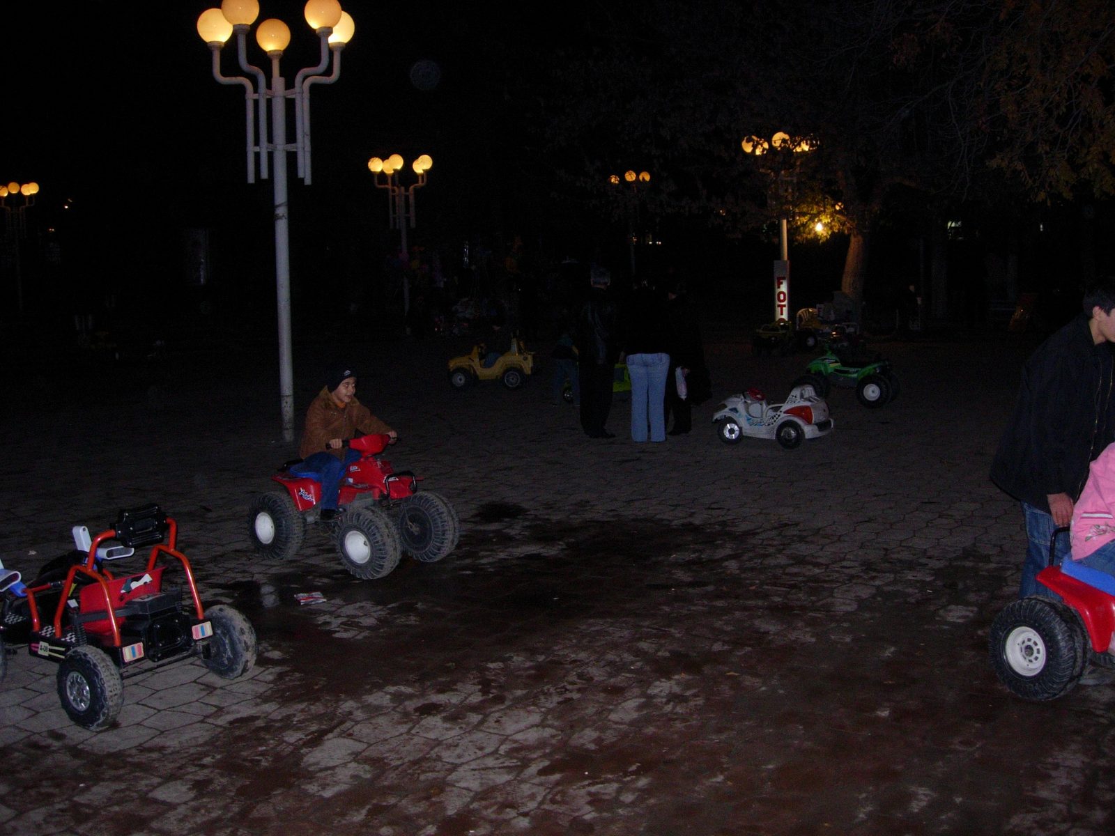 In Baku, children of fashion promenade about unlit public squares in motorized toy cars while...