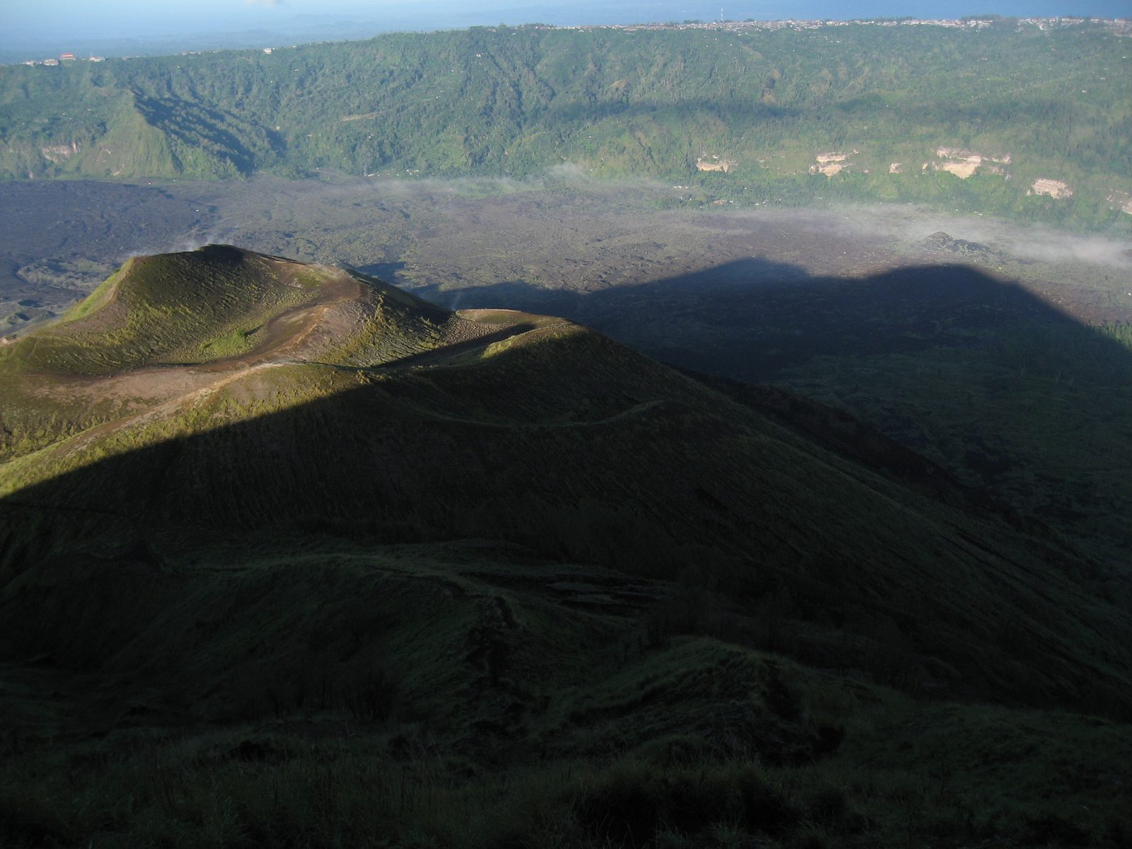 Gunung Batur's shadow cast across the devastated area from an early 20th century eruption.  Can...