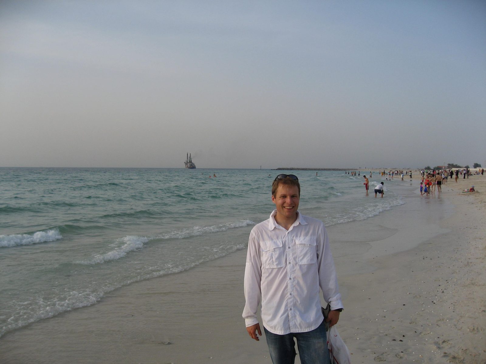 John on the beach in Dubai, near the Burj al Arab.