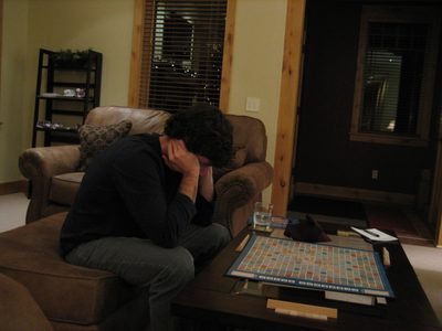 Jay studies his Scrabble tiles in a Christmas Eve game.