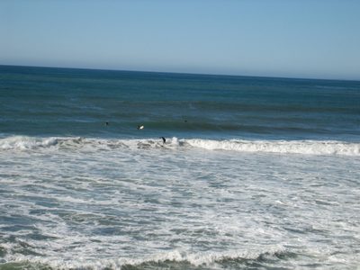 A surfer finishes a ride in.